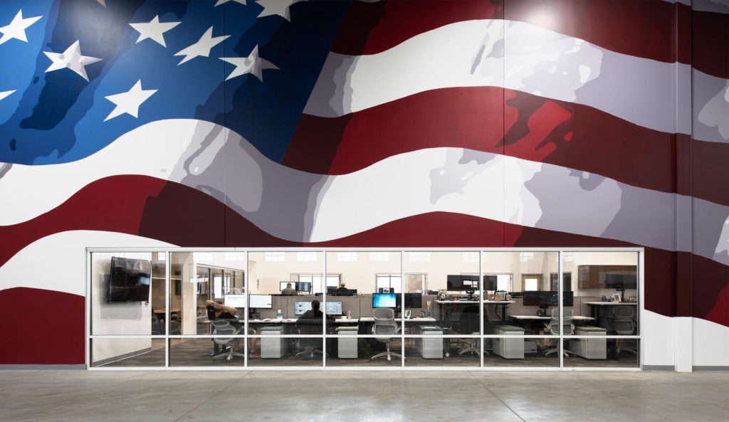 American flag decal on wall with office below it.