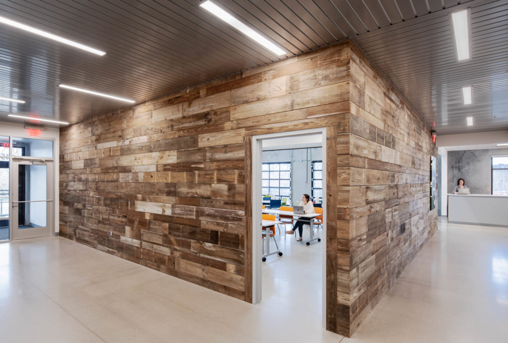 Office area with wood paneling and an open door.